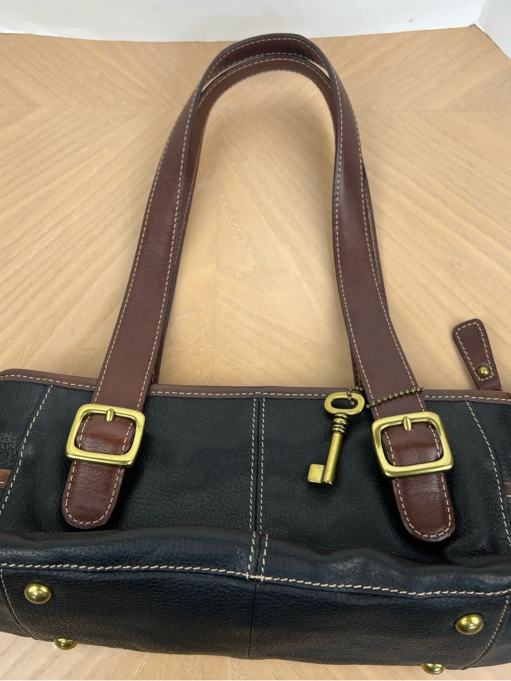 Fossil Black Leather Shoulder Bag with Brown Straps and Brass Key Charm